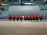 a table with a bunch of red balls on top of it