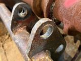 a rusted pipe with two bolts attached to it