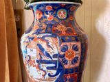 a blue vase with white flowers in it on a table