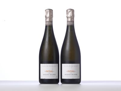 two bottles of wine sitting next to each other on a table