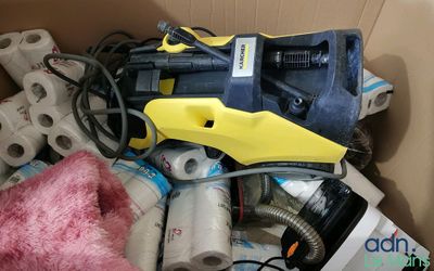 a box full of assorted items including a blow dryer and a stuffed animal