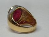 yellow gold ring with red stone and diamonds on top