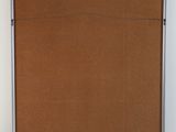 a picture of an empty room with a brown board