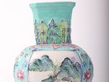a blue vase with a painting on it sitting on a table