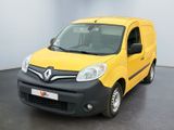 une camionnette jaune et noire garée dans une pièce aux murs blancs