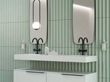 two sinks in a bathroom with two mirrors on the wall