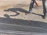 a man that is standing in the street with a skateboard