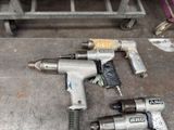 two air tools that are sitting on the floor