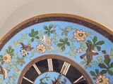 a clock that is decorated with birds and flowers