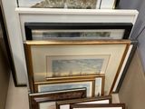 a lot of framed pictures in a box on the floor