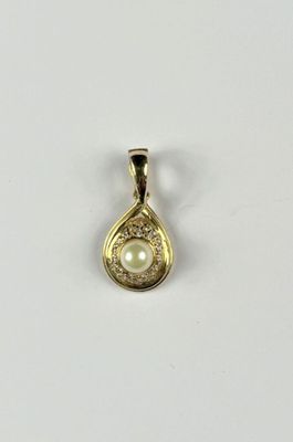 a yellow gold pendant with a pearl in the center