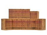a stack of books sitting on top of each other on a white surface