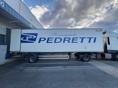a semi truck that is parked in front of a building