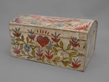 an old wooden box with painted flowers and leaves on it