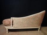 an old fashioned couch with a pillow sitting on top of it