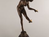 an image of a bronze statue of a woman holding a tennis racquet