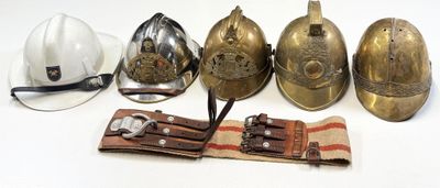 five different types of helmets and a hat on a table