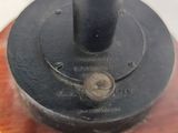 a close up of a black object on a wooden base