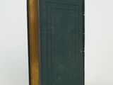 a book with a green cover sitting on a white surface