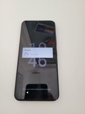 a close up of a cell phone on a white table