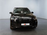 the front view of a black audi car in a showroom