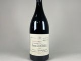 a bottle of wine sitting on top of a white table