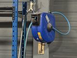 a blue hose attached to the side of a metal pole