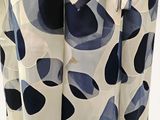 a close up of a curtain with a blue and white design