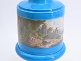 a blue vase with a painting on it sitting on a pedestal
