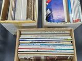 two boxes filled with books sitting on top of a table