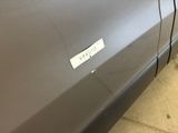 a sticker on the door of a car that is parked in a garage