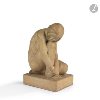 sculpture of a man sitting on a wooden block with his head in his hands