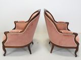 pair of pink velvet upholstered chairs with walnut wood legs