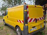 a yellow van that is parked in front of a barn