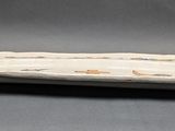 a white plate with a design on it sitting on a table