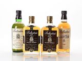 three bottles of different types of whisky on a white surface