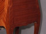 a small wooden table with a marble top on it