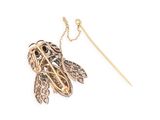 an image of a gold and diamond broochle with a chain