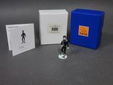 a small figurine of a man on a skateboard in front of a box