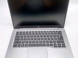 an open laptop computer sitting on top of a white table