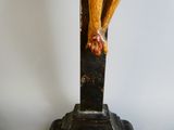 a statue of a person on a cross on a pedestal