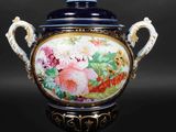 an image of a blue and white vase with flowers on it