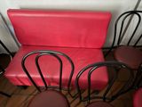 four chairs and a bench in the corner of a room