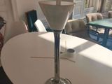 a white table with a glass vase on top of it