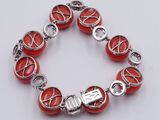 a close up of a bracelet with red beads on a white surface