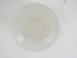 underside view of a clear glass plate on a white surface