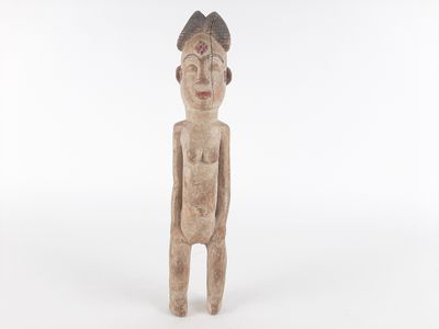 an old wooden statue of a man with a hat on his head