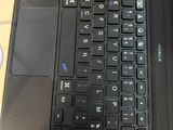 a black laptop computer sitting on a desk with a mouse