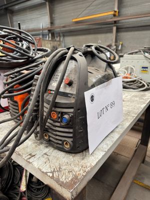 a lot of wires on a table with a sign on it