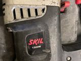 a close up of a drill with a red handle